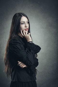 Dark young woman in thinking position