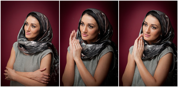 Attractive brunette woman in gray blouse and headscarf posing 