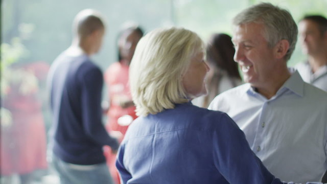 Romantic mature couple dancing together at a party