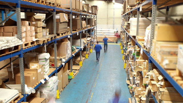 Time lapse of male workers in warehouse preparing goods for dispatch