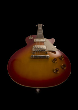 An electric guitar on a black background