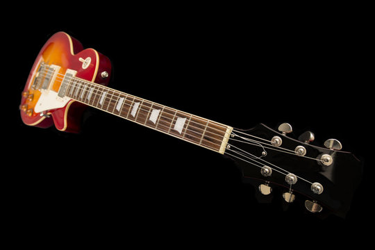 An electric guitar on a black background
