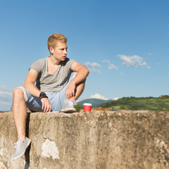 Naklejka na ściany i meble Young hipster blond man outdoors in summer