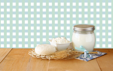 Tzfatit cheese , cottage and milk on wooden table over retro rur