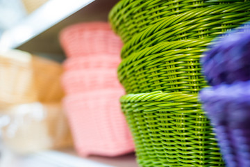 Obraz na płótnie Canvas Colored wicker basket on the shelf
