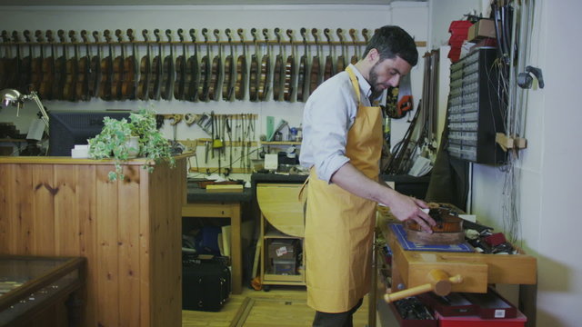 Portrait of shopkeeper in a violin shop