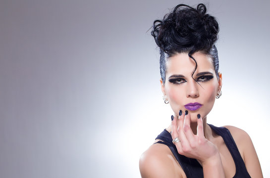 Girl with purple lipstick and short black hair