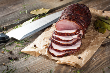 Smoked ham on a chopping board. - obrazy, fototapety, plakaty