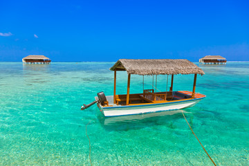 Boat and bungalow on Maldives island
