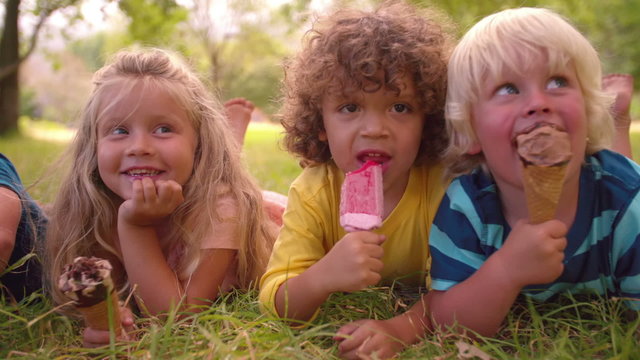 Mixed racial group of child friends eating ice creams