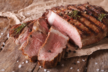 sliced beef steak medium on an old table. Horizontal close-up