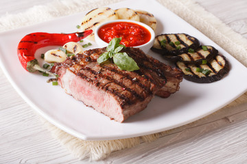 beef steak, grilled vegetables and sauce close-up. horizontal