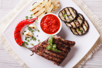 beefsteak, grilled vegetables and sauce horizontal top view