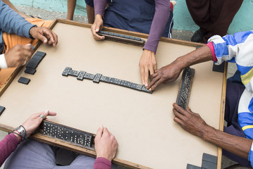Cropped image of people playing domino on street