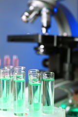 Test tubes on microscope background