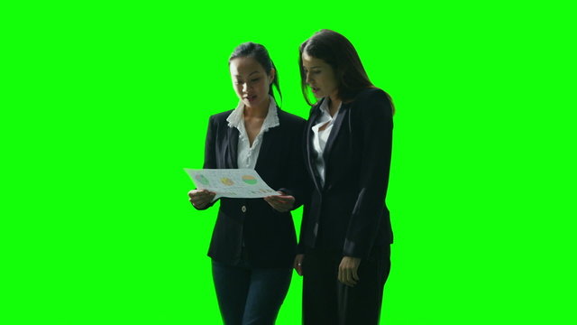 2 businesswomen having a conversation on green screen background