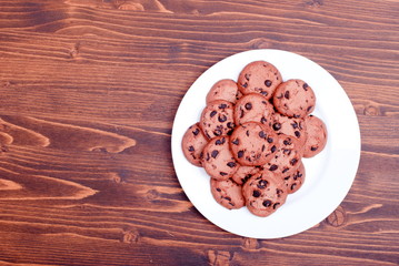 Delicious chocolate chip cookies on the board top view