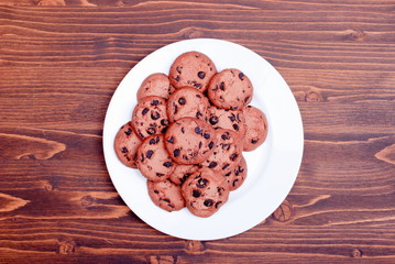 Delicious chocolate chip cookies on the board top view