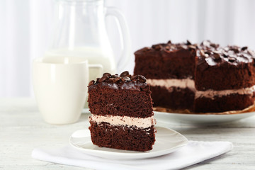 Delicious chocolate cake on table on light background