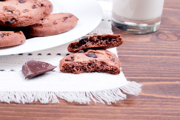chocolate chip cookies with milk on the board top view