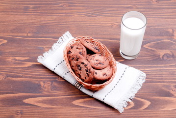 chocolate chip cookies with milk on the board top view