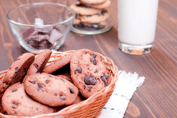 chocolate chip cookies with milk on the board top view