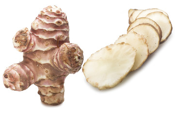 Topinambur, cut into slices on the white