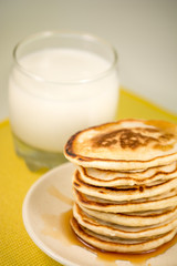 Hot pancakes with maple syrup and milk