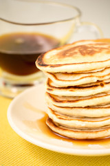 Fototapeta na wymiar Hot pancakes with maple syrup