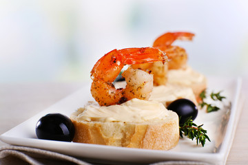 Appetizer canape with shrimp and olives