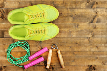 Shoes and sports equipment on wooden floor, top view