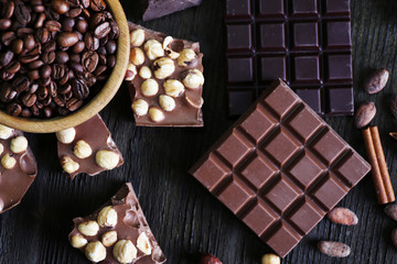 Set of chocolate with nuts on wooden table, top view