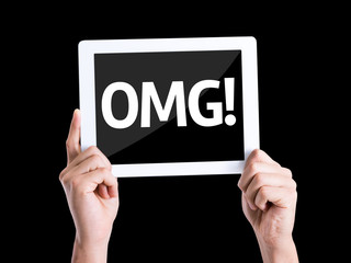 Tablet pc with text OMG (Oh My God) isolated on black background