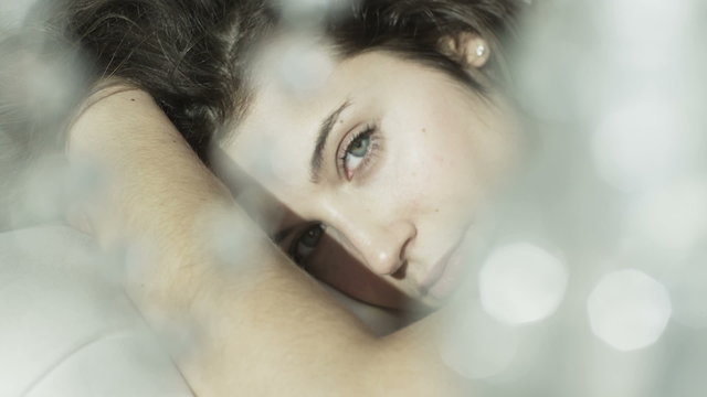 Close up of sultry brunette model relaxing in her boudoir