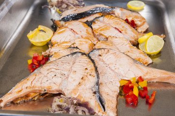 Salmon steak slices at a restaurant buffet