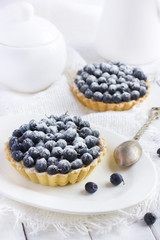 tart with fresh bluebeeries and icing sugar