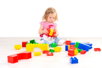 little girl playing with colorful blocks