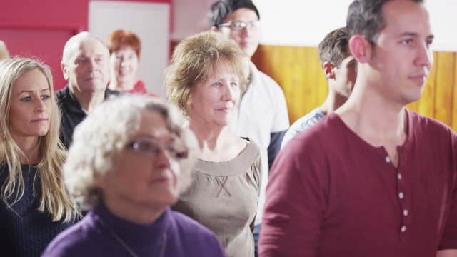 Church group bow their heads to pray