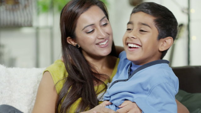 A mother showing her son lots of love
