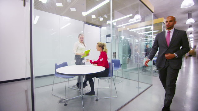 Young businesswoman interviewing job applicant in modern city office