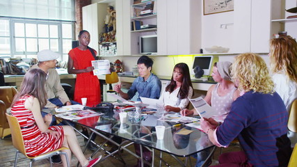 Attractive young creative design team in a business meeting - Powered by Adobe