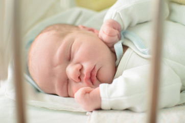 newborn baby sleeping in crib