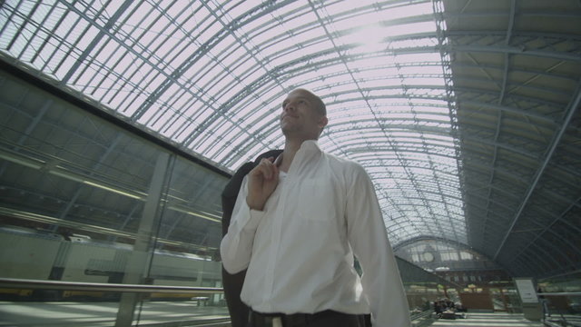 Businessman walking through St. Pancras railway station in London