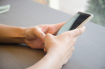 Close up of a man using mobile smart phone
