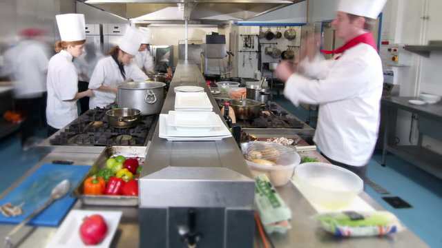Time lapse of busy team of chefs preparing food in a commercial kitchen