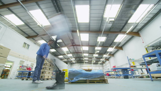 Time lapse of male workers in warehouse preparing goods for dispatch