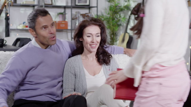 Young girl reading to her parents