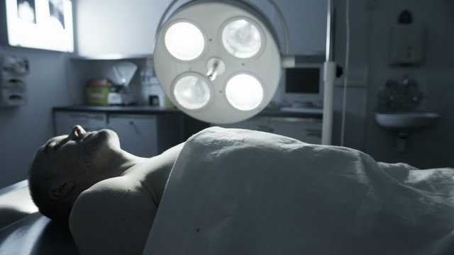 Dead male body laid out on an autopsy table