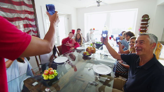 Happy group of family and friends, socializing together at the dinner table 