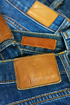 Pile of blue jeans closeup label